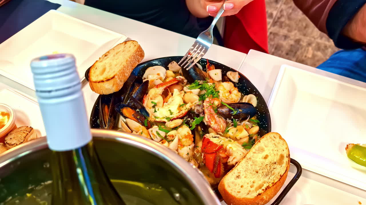 Delicious seafood meal at restaurant with wine in ice, close up