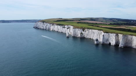 speedboat sailing near cliffs of old harry rocks, jurassic coast, uk