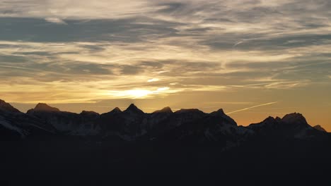 Sunset-over-the-Amden-mountains-in-Glarus,-Switzerland,-with-vibrant-sky-colors-and-silhouette-peaks