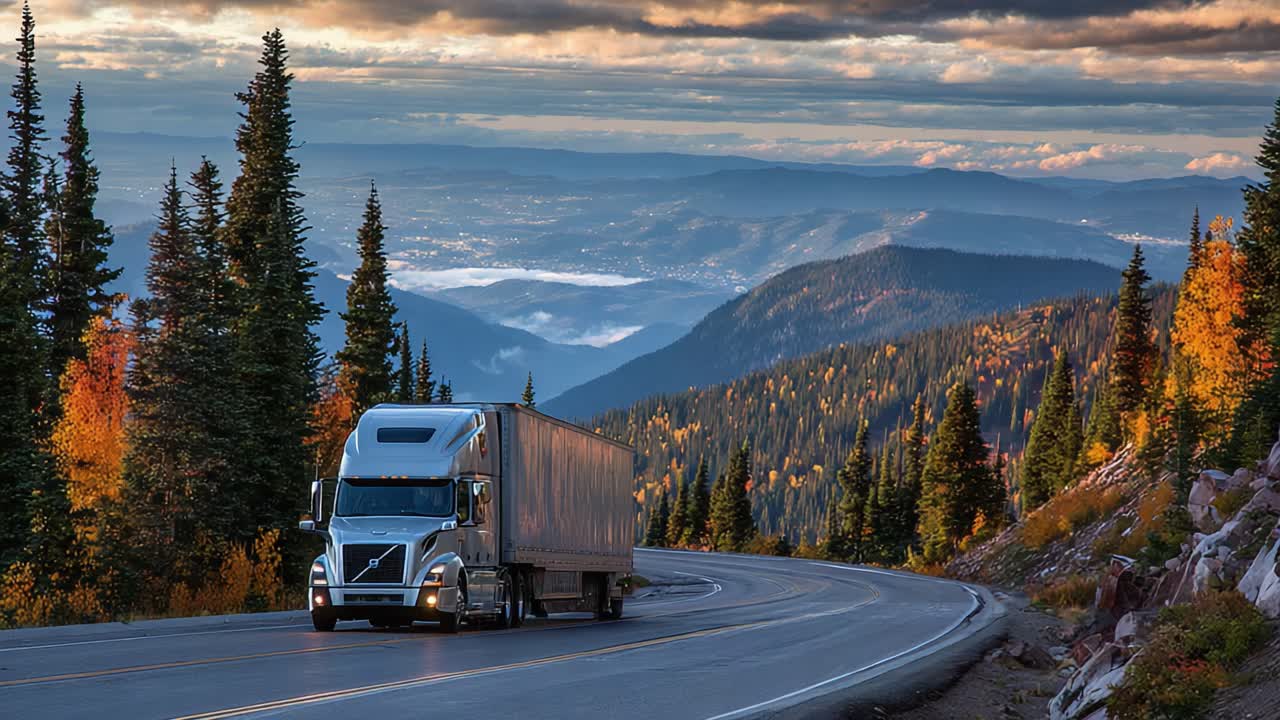 A Majestic Journey Through Autumn Mountains: A Truck Navigating Winding Roads Surrounded by Vibrant Fall Foliage and Stunning Valley Views