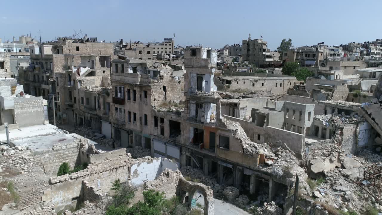 uma visão aérea com um drone sobre edifícios de aleppo, na síria, 10 anos após a guerra civil, podemos ver grama cobrindo ruínas de edifícios destruídos após bombardeios.