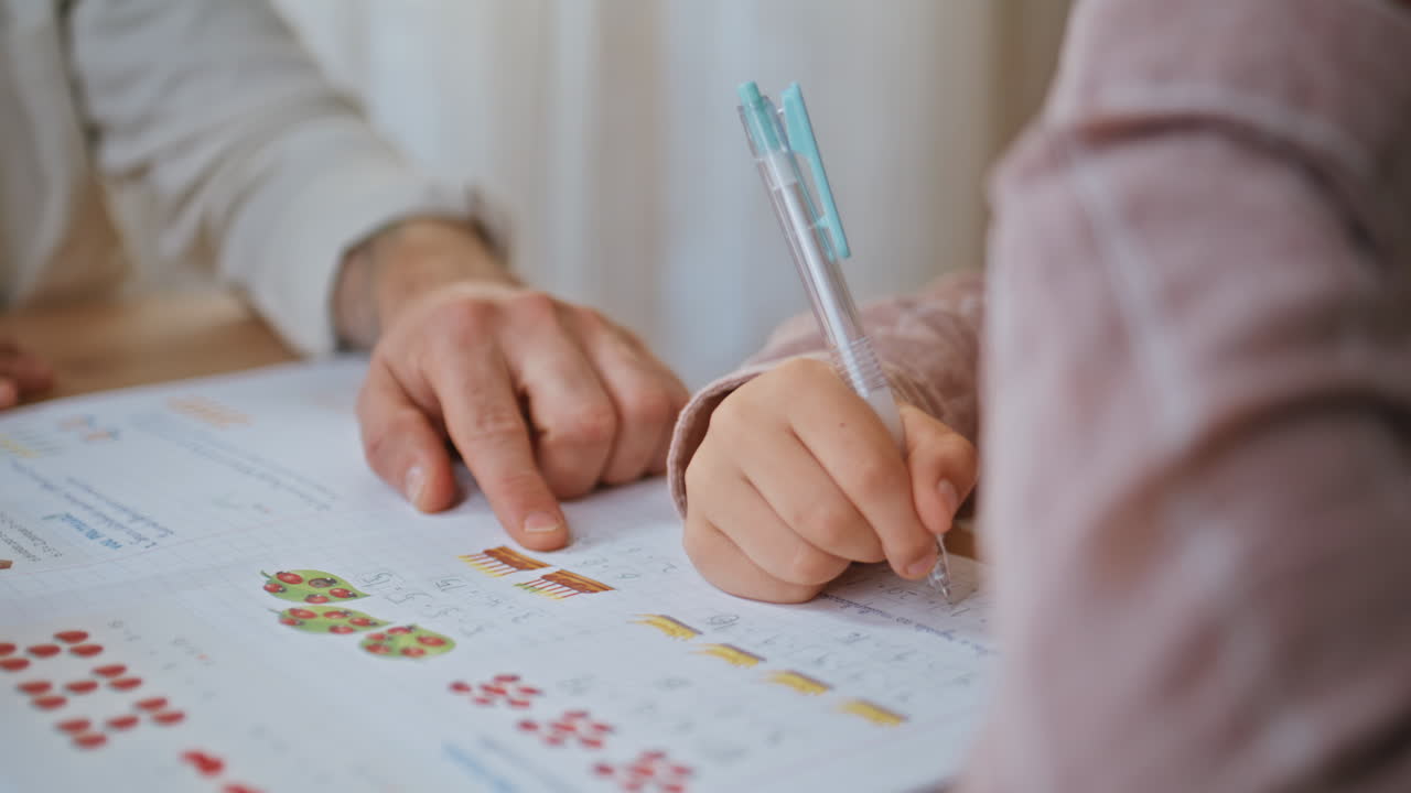 Primary school teacher pointing finger at notebook closeup.Boy writing homework