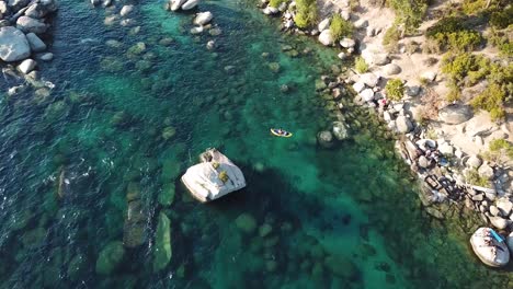 Aerial-View-on-Kayak-in-Water-Near-Sand-Harbor-Beach-on-Lake-Tahoe,-Sierra-Nevada,-USA