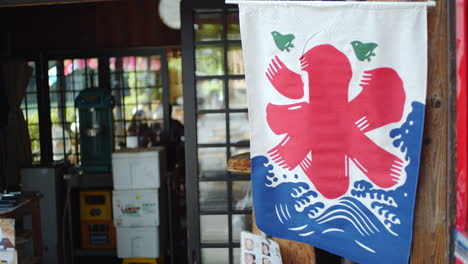 flag with the ice kanji hanging outside of a restaurant in kyoto, japan soft lighting