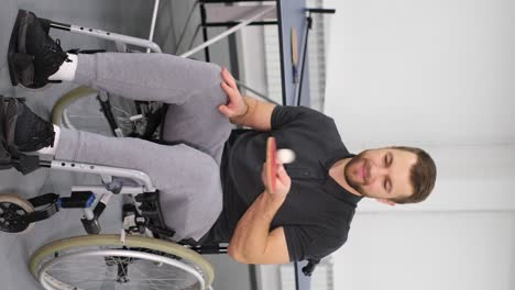portrait of a handsome young man in a wheelchair with a table tennis racket portrait of a handsome young man in a wheelchair with a table tennis racket sports for the disabled