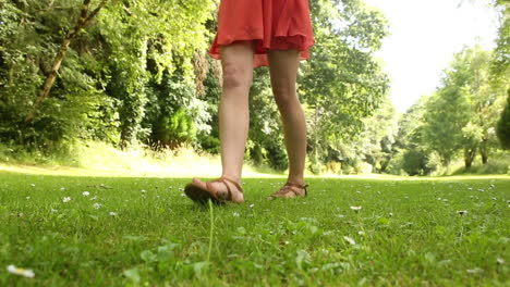 beautiful teen walking on the grass on a sunny day