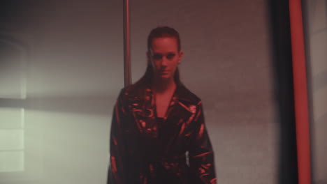 woman in leather coat by a pole