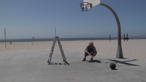 a basketball player slam dunks while standing on a step ladder