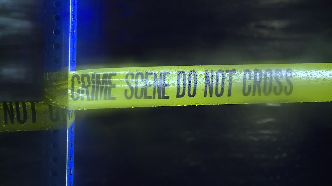 CRIME TAPE AT NIGHT IN THE RAIN