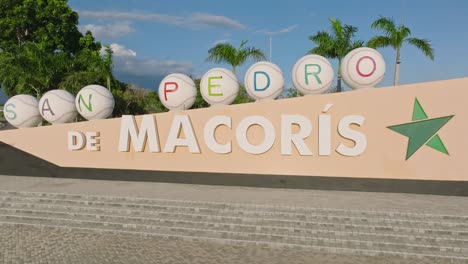 zoom out shot of san pedro de macoris logo in city beside highway during sunset time