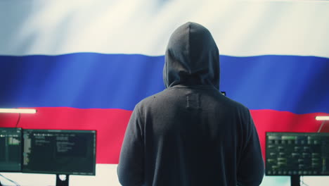 expert in governmental hacking room with a russian flag on big screen