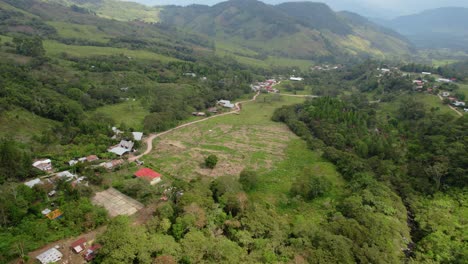 aerial view of a rural village nestled in a mountainous green valley