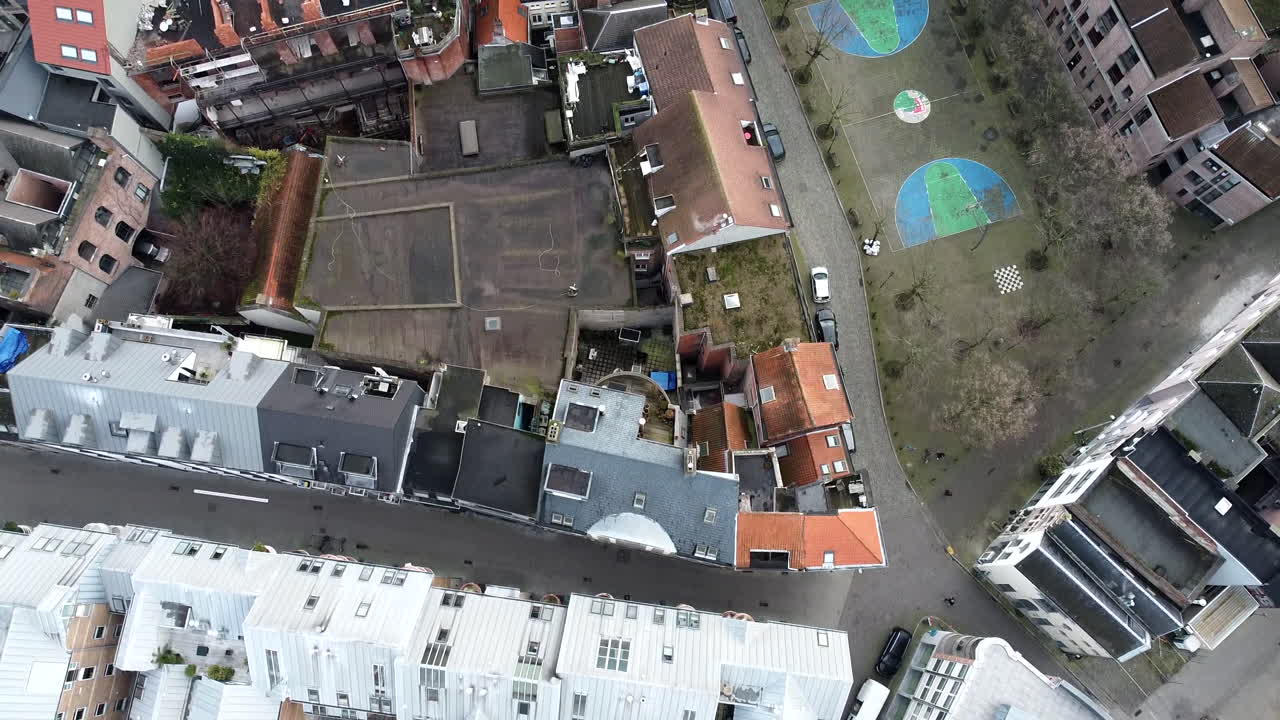 Slow aerial birds eye overview shot of belgian residential area beside church