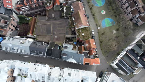 slow aerial birds eye overview shot of belgian residential area beside church
