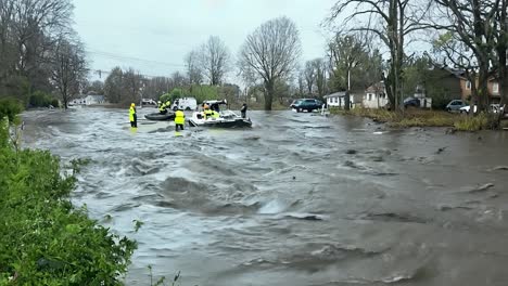 flood rescue workers helping people in a flooded street