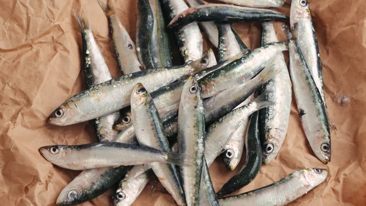 Pile of Fresh Sardines on Brown Paper