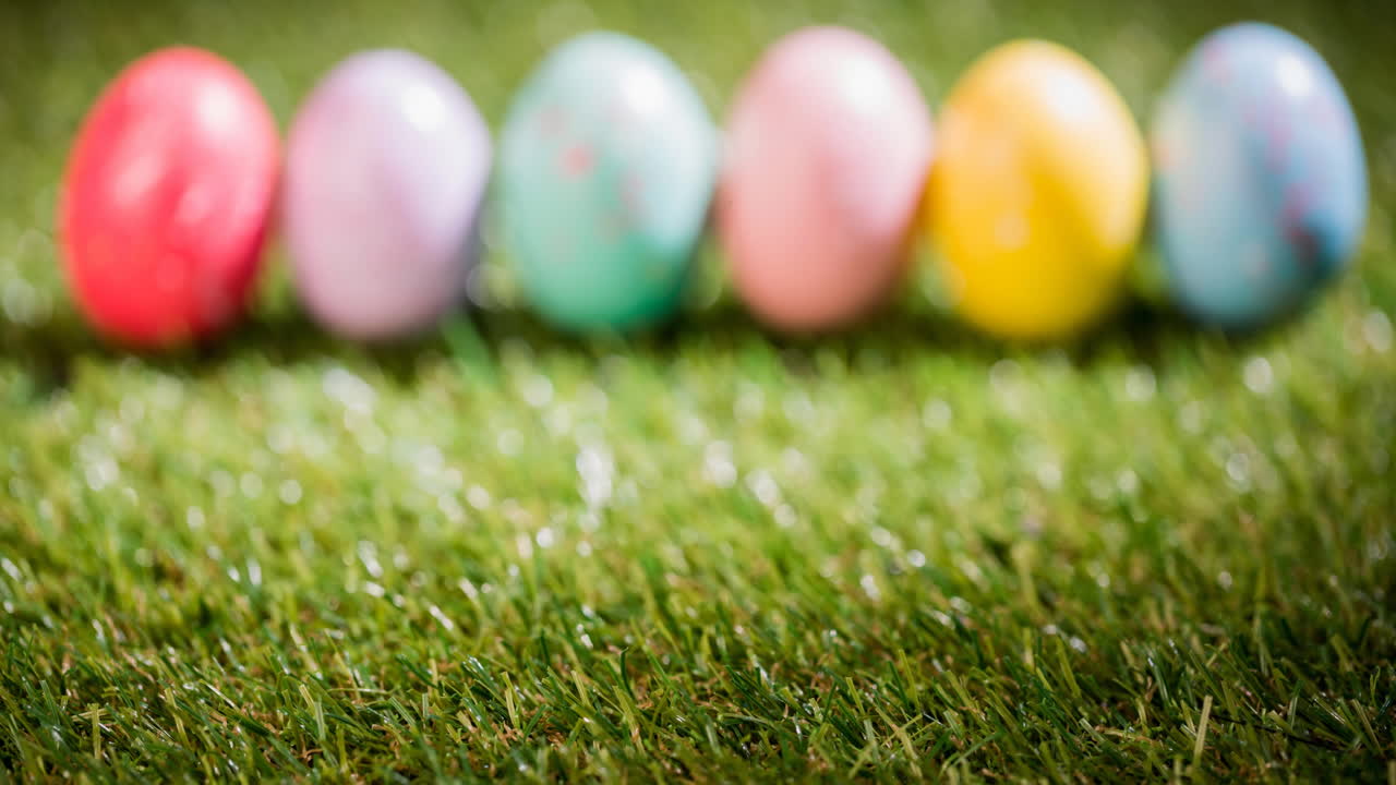 Animation of colourful easter eggs on grass