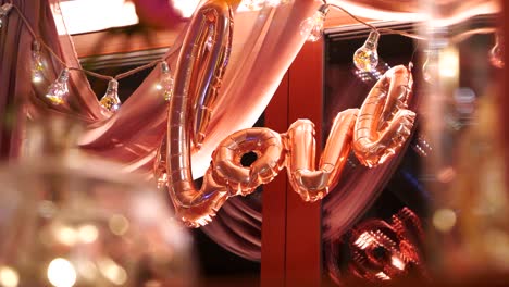 focus shift to the "love" inscription made of pink balloons