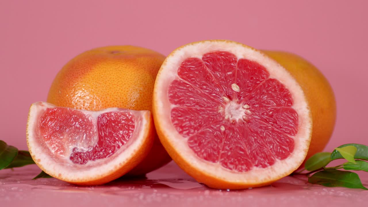 Fresh grapefruit with leaves rotates slowly.