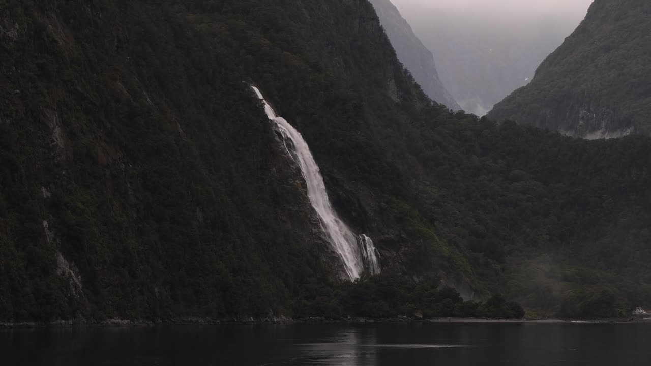 Beautiful waterfall at Milford Sound (Piopiotahi), Fiordland National Park on the South Island of New Zealand.