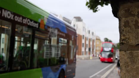 green bus driving through oxford street