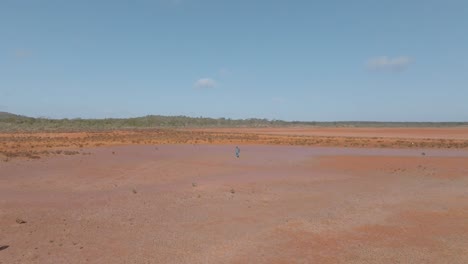 Panning-drone-clip-of-solo-male-hiker-walking-through-remote-Australian-outback