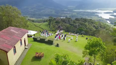 aerial drone shot: the guests attending a wedding at a gorgeous location in the mountains