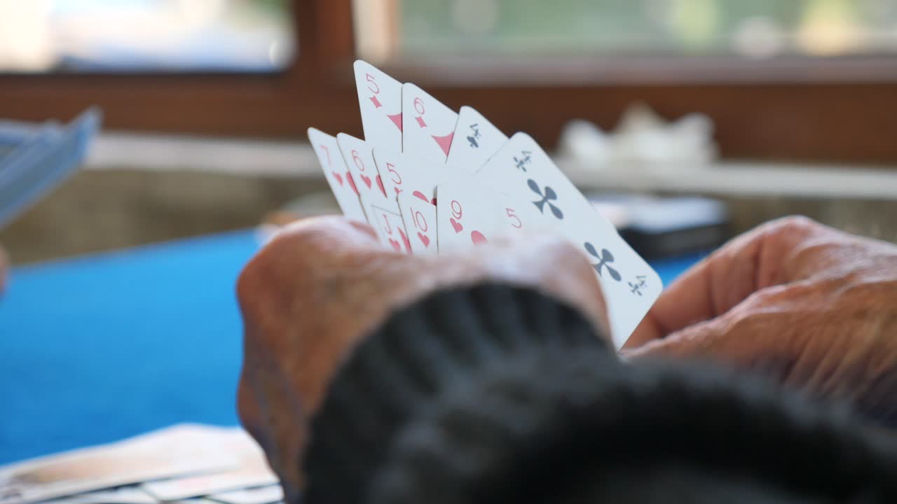 Playing cards with elderly hands