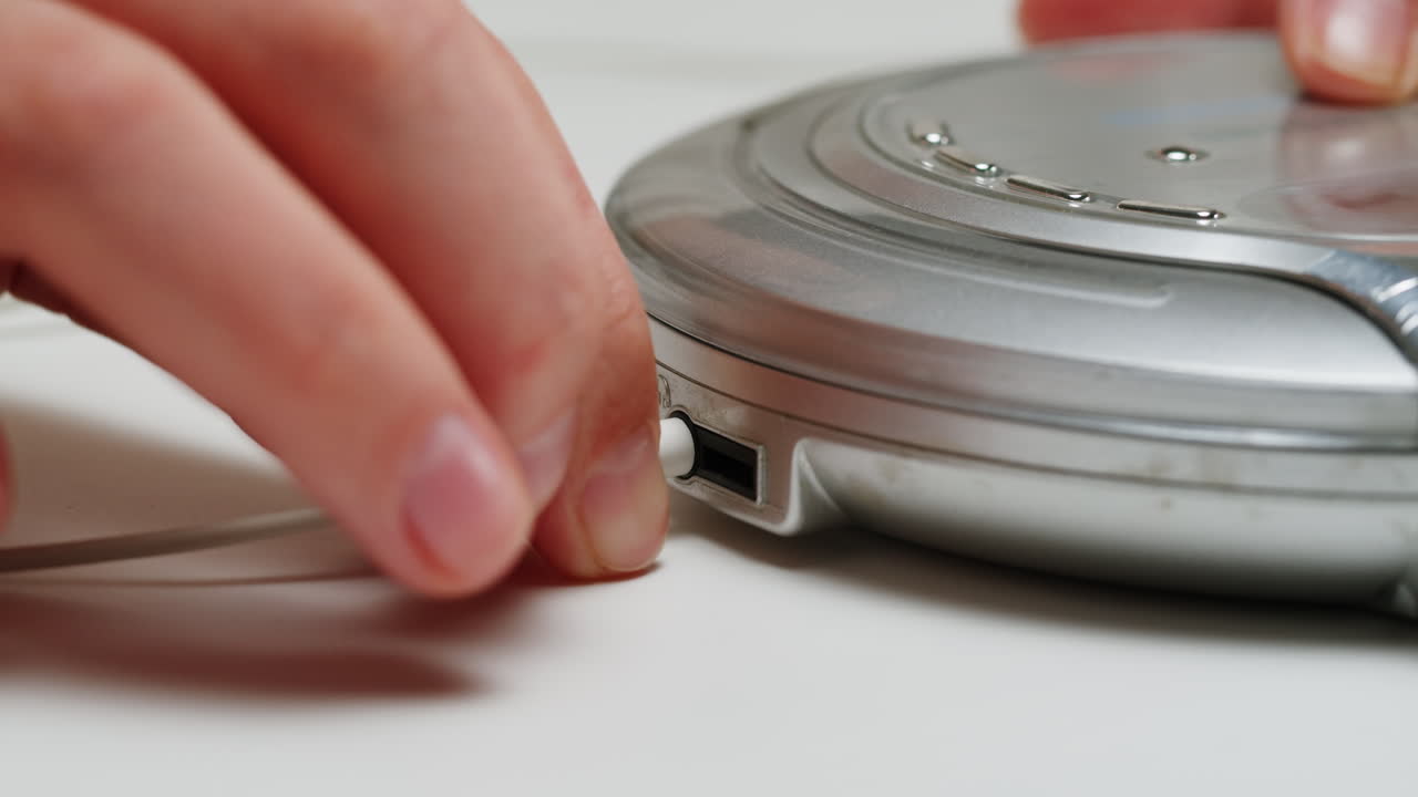 Using headphone for old music portable compact player close-up. Listen to music with vintage player.