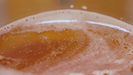 detail view of a beer in the upper area where the protective foam protects it from spoiling