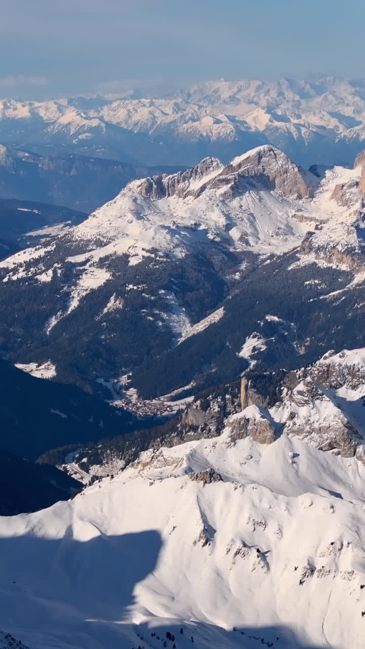Aerial drone view of the Marmolada mountain in the Dolomites, northeastern Italy with the blue sky on the background. Vertical