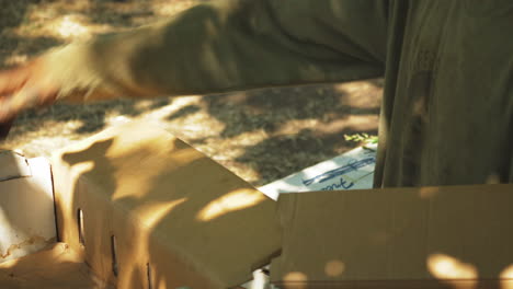 unrecognizable person organizing cardboard boxes