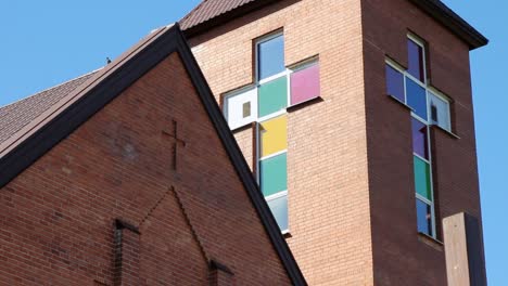 stained glass window in church building exterior. catholic church steeple