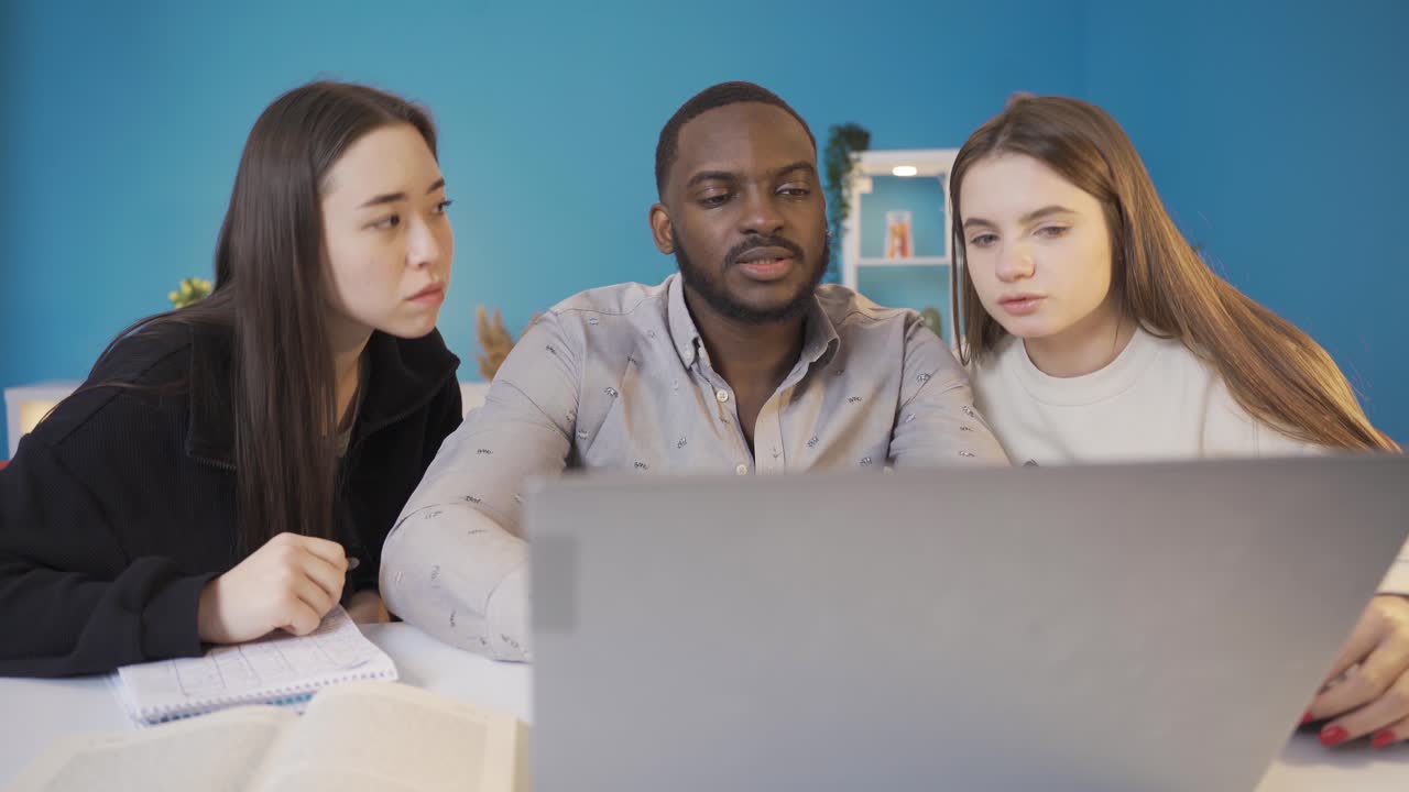 University students of different races working on laptop.
