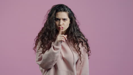 woman making a 'hush' gesture