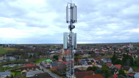 telecommunication tower overlooking houses on a cloudy day