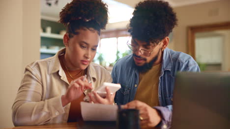 couple working on their finances at home