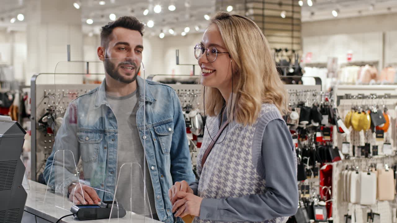 Beautiful Couple Buying Clothes With Card
