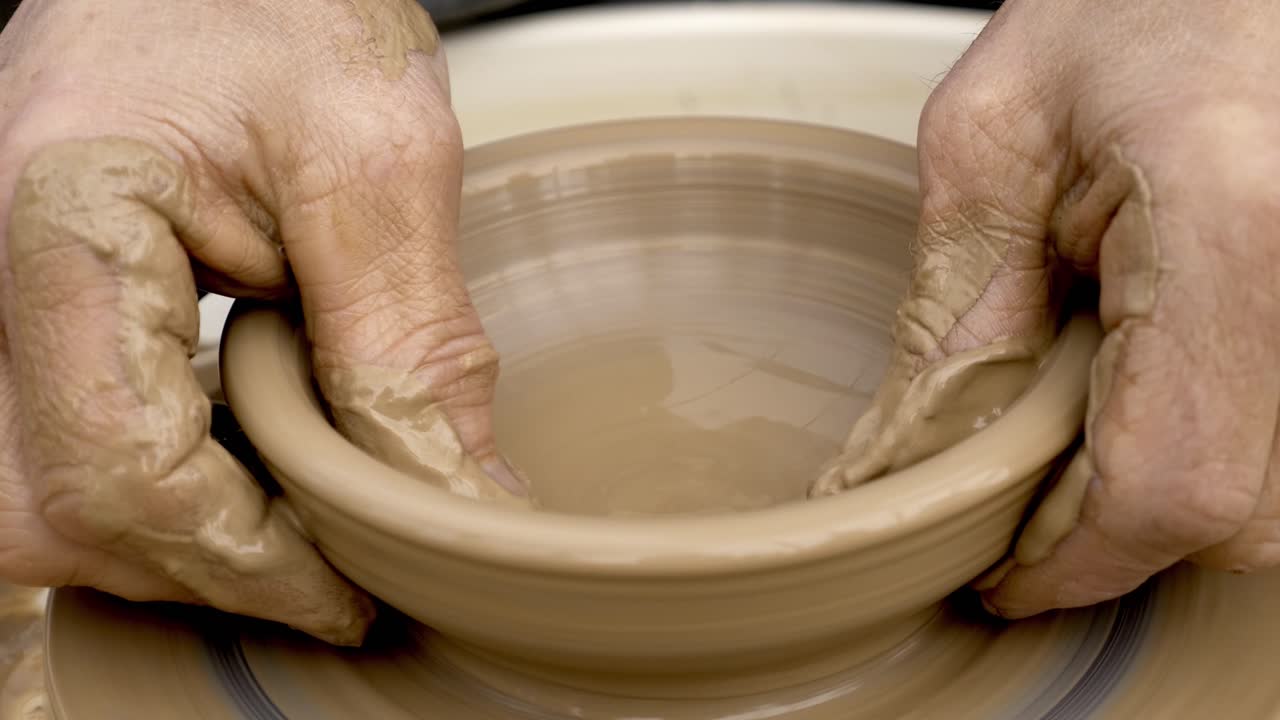 Hands Shaping a Bowl on a Pottery Wheel