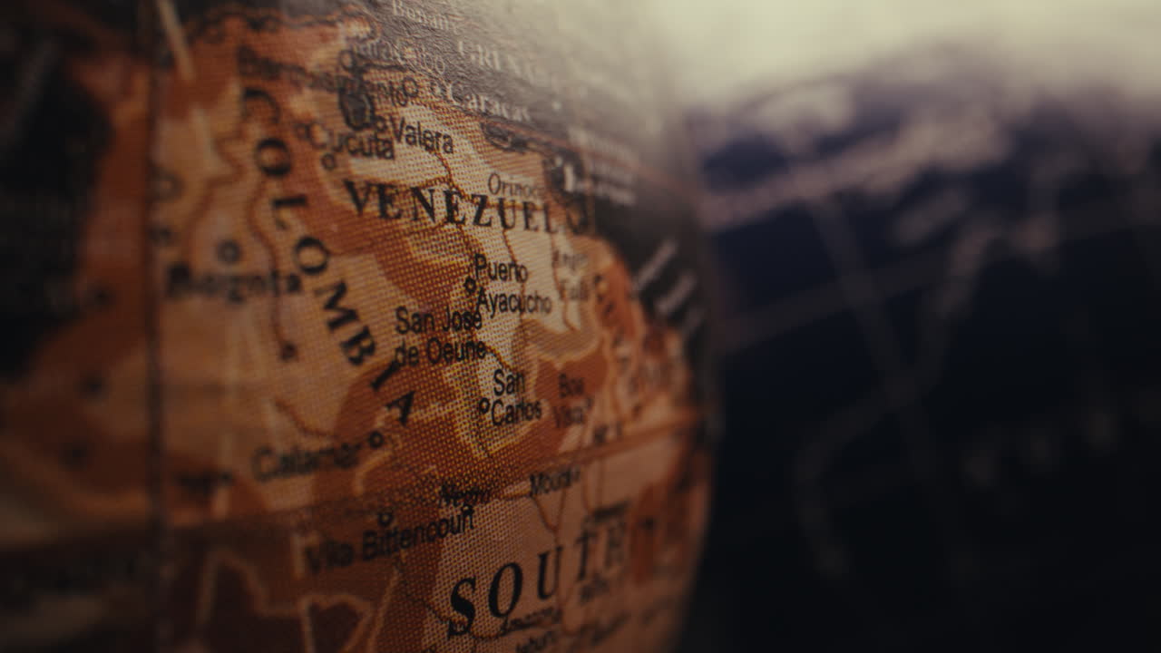 Close-up of a vintage world globe, focusing on Colombia and Venezuela