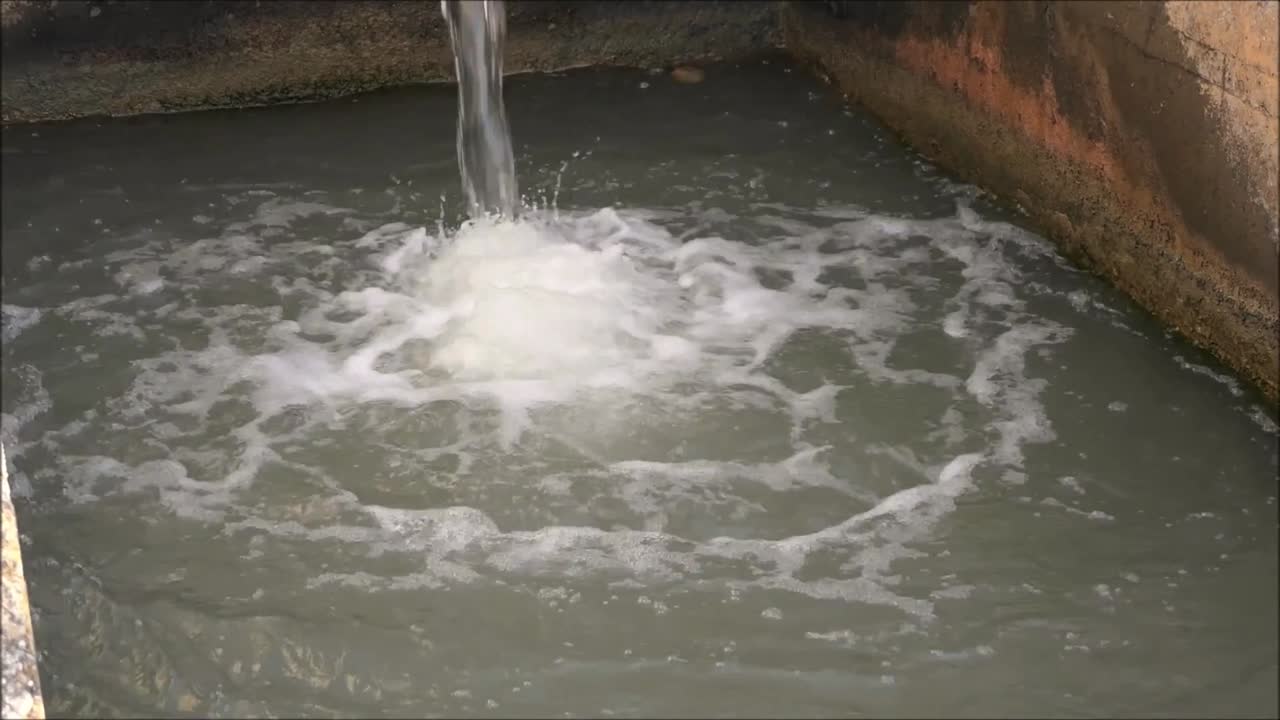 Irrigation system in Andalusia. Elevated Concrete irrigation canal dropping down a level in countryside in Andalucía