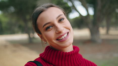 cheerful girl laughing happily standing on nature close up. portrait happy woman