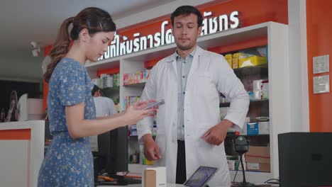 asian woman scanning a barcode at a smartphone for contactless payment. digital wallet, mobile app, mobile payment.