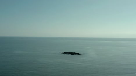 wide angle aerial view of island in the middle of ocean, no people