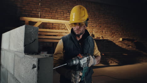 construction worker drilling brick wall
