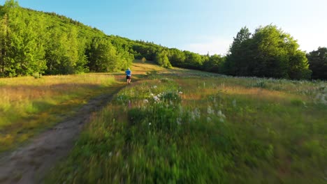 Man-jogging-along-a-path-in-Knox-County-Maine,-USA