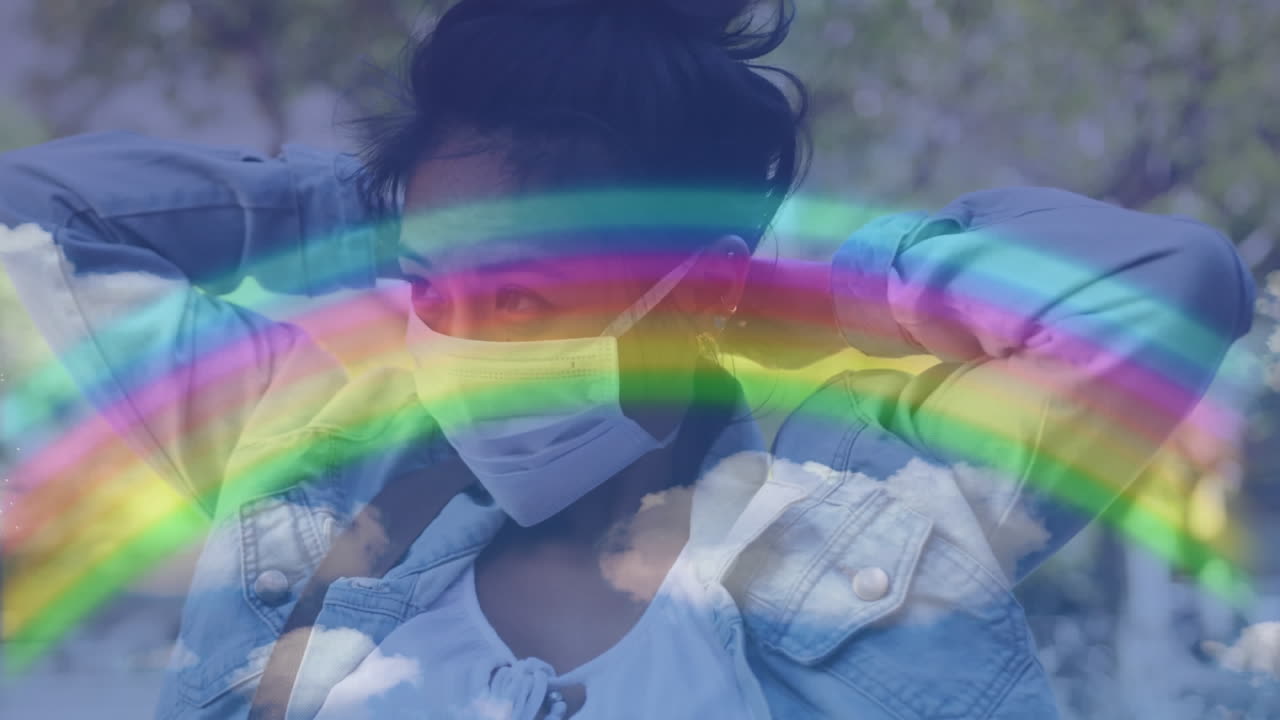 Rainbow against woman wearing face mask