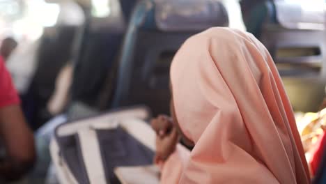 woman in hijab on a bus