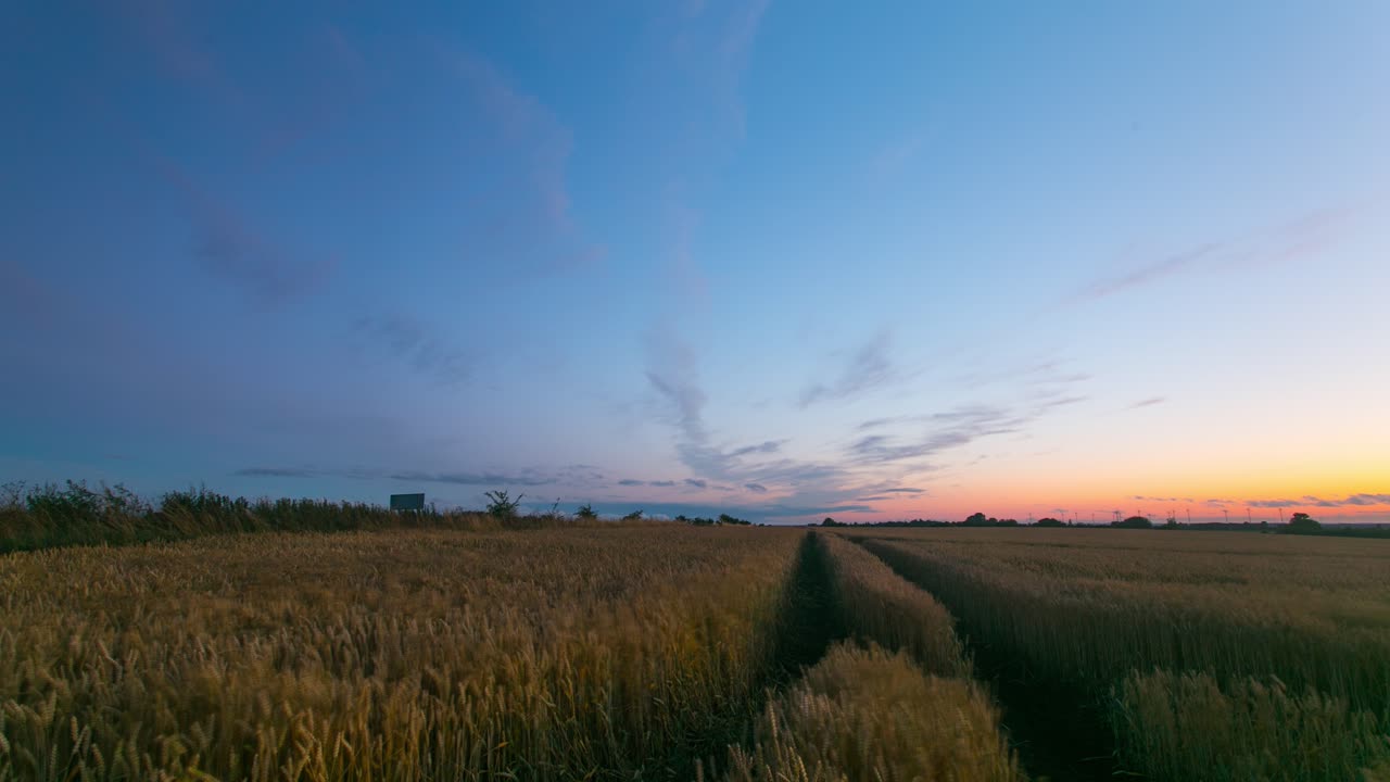 The beautiful fiery sunset colors over a farm field in Zlotoryja, Poland - time lapse
