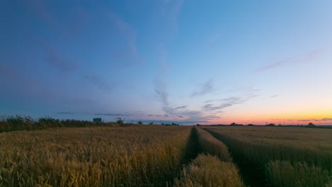 the beautiful fiery sunset colors over a farm field in zlotoryja, poland - time lapse